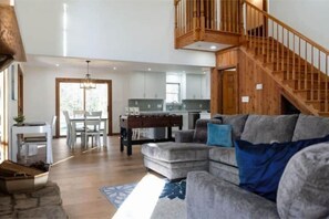 Relax in this stylish living area with a sofa, coffee table, and dining space.