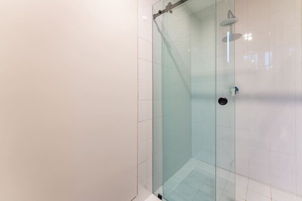 A glass-enclosed shower with a handheld showerhead and a wall-mounted faucet. - Group-Friendly Stay in Walkable Roma Norte (Ciudad de México)