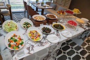 A buffet with various dishes including salads, fruits, and vegetables. - Mercure Guangzhou Baiyun International Airport (Guangzhou)