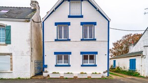 A two-story building with a gabled roof, white exterior, and blue window frames. - Hon Ty Glas - Maison proche de plage avec jardin (Moëlan-sur-Mer)