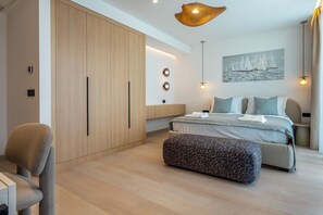 A modern bedroom with a large bed, a wardrobe, and a desk. - Villa Rora - Four Bedroom Villa, Sleeps 8 (Brela - Krug)