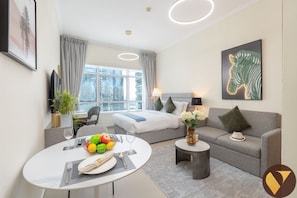 Relax in a stylish space with a large bed, sofa, and city views.