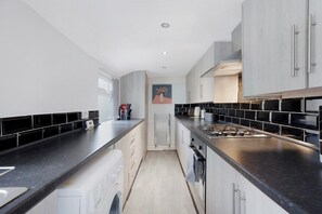 Enjoy cooking in this kitchen with a central island, stove, and ample counter space.
