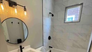 A bathroom with a sink, mirror, toilet, and bathtub. - Homestay In Fields Corner Area Boston (Boston)