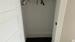 A closet with hanging clothes and a door. - Homestay In Fields Corner Area Boston (Boston)