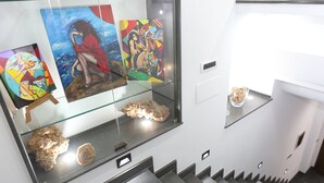 A staircase with glass display cases containing artwork and decorative items.