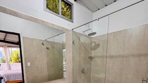 A modern bathroom with a glass-enclosed shower, a white sink, and a toilet. - GLAMPING WITH POOL AND JACUZZI AT GUATAPE  (Antioquia)
