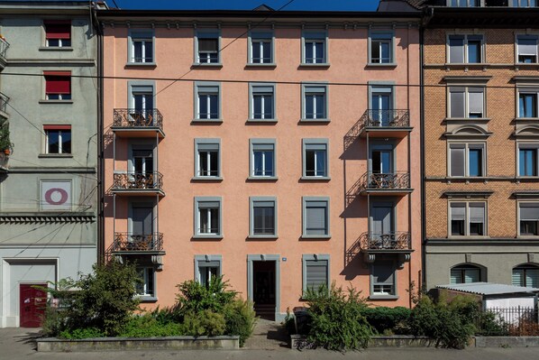 Stylish city living with traditional European flair, featuring balconies and uniform shutters.