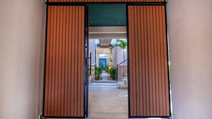 A modern building entrance with a wooden facade and a clear view into the interior.