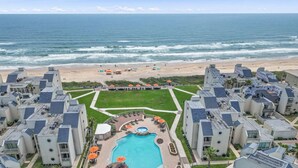 A beachfront hotel with a swimming pool, beach umbrellas, and ocean views. - BahiaMar Luxury Oceanfront Oasis (South Padre Island)