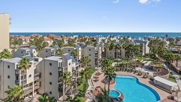 A resort with multiple buildings, a swimming pool, and a view of the ocean. - Amazing Panoramic Ocean Paradise (South Padre Island)