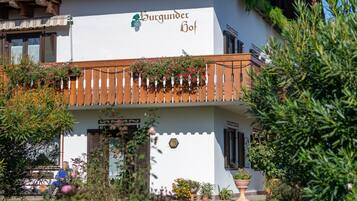 A two-story building with a sign reading 'Burgunder Hof' on the facade.