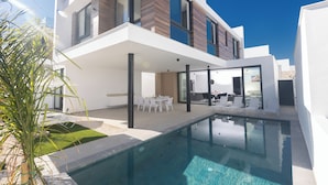 A modern two-story house with a swimming pool, outdoor seating, and a well-maintained lawn. - Villa Malin, Brand New, 5BDR Protaras Villa with Heated Pool (optional) (Protaras)