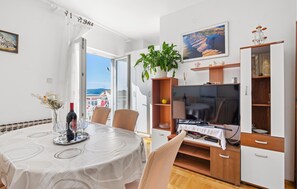 Enjoy meals for two in this cozy dining area with a round table, television, and scenic view.