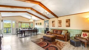 A spacious living area with a dining table, a sofa, and a patterned rug. - Deer Harbor Cottages, Entire Property. Sleeps up to 16. 3 Hot Tubs. 4 Bedrooms. (Eastsound)