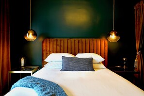 A hotel room with a large bed, two bedside tables, a nightstand, and a wall-mounted lamp. - Palm Springs' hottest new boutique hotel can be all yours. Sleeps up to 22 VIPs. (Palm Springs)