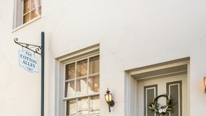 A white building with a sign reading "424 Cotton Alley."