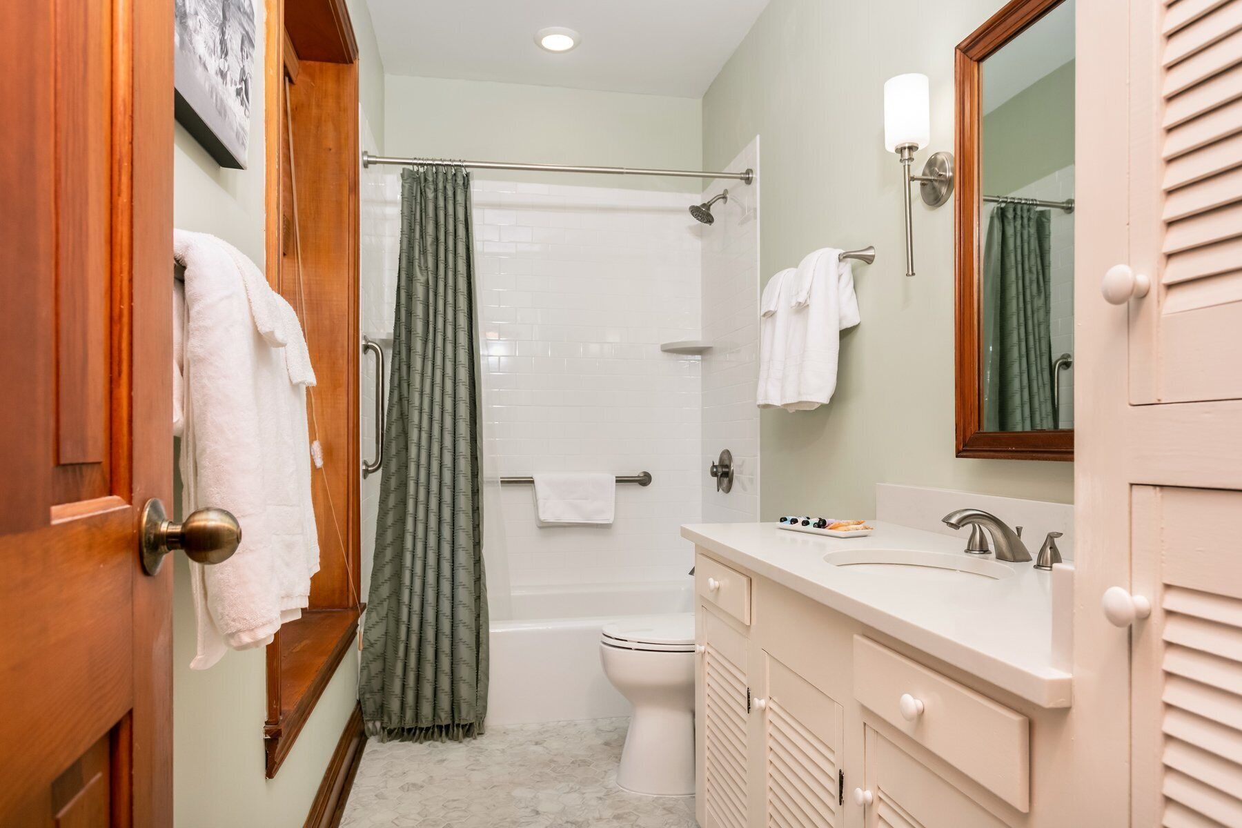 A bathroom with a shower, toilet, and sink.