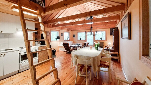 A wooden cabin interior with a kitchen, dining area, and a loft bedroom. - 2 bedroom lovely home in Klippan (Klippan)