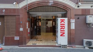 The entrance to a building with a sign reading "KIRIN" and a tiled floor. - STAY OSAKA NANBA (Osaka)