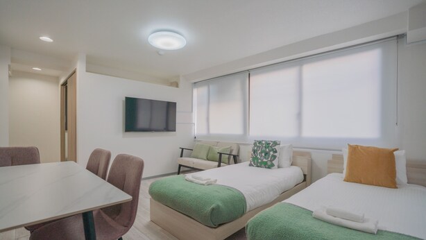 A hotel room with two beds, a dining table, and chairs. - STAY OSAKA NANBA (Osaka)