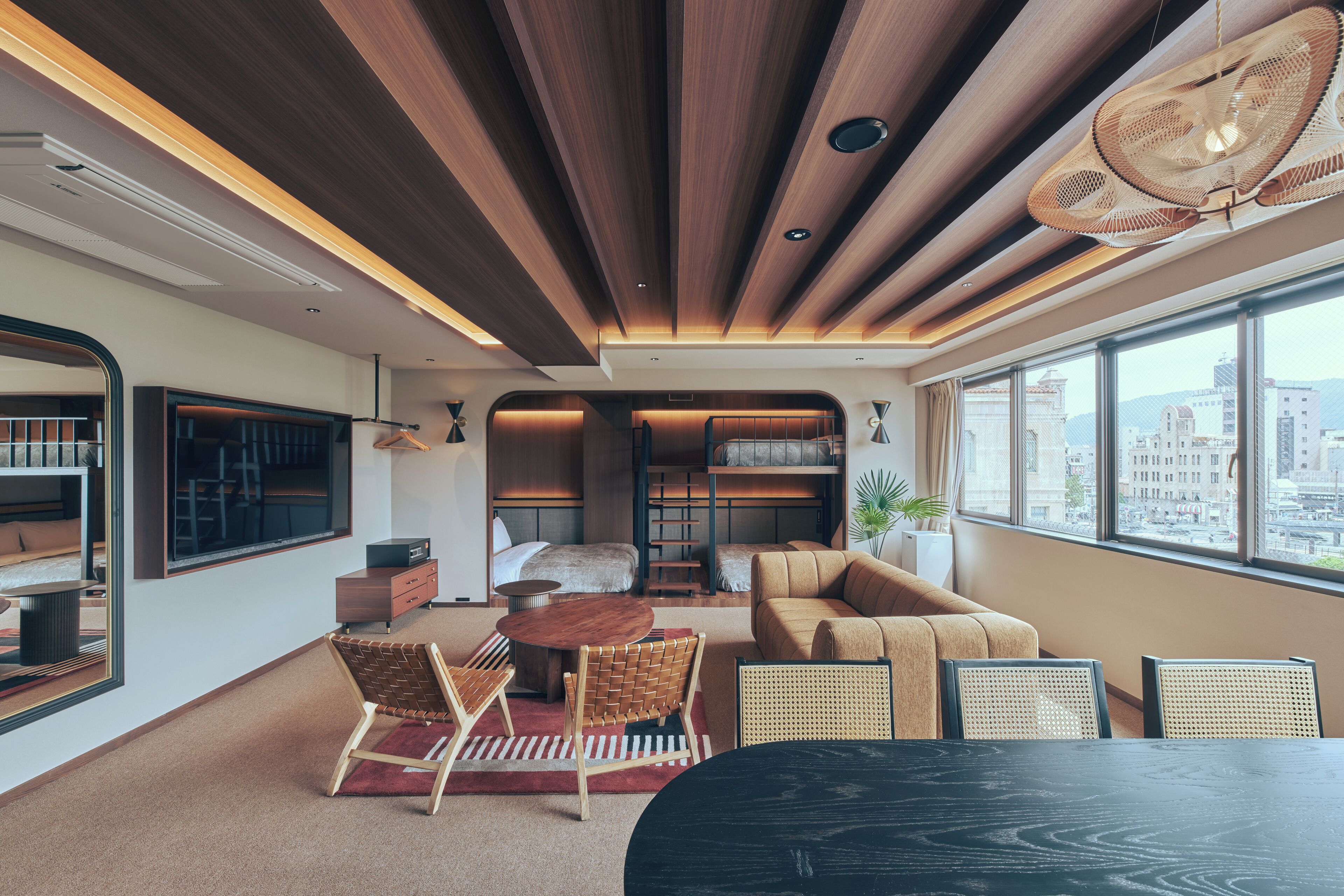 A modern interior with a wooden ceiling, a dining area with a round table, and a sofa.