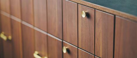 A wooden cabinet with a black countertop.