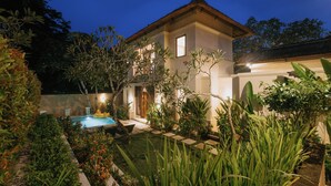 A two-story house with a swimming pool, surrounded by lush greenery and well-maintained gardens. - Villa Anggrek Jimbaran (Jimbaran)