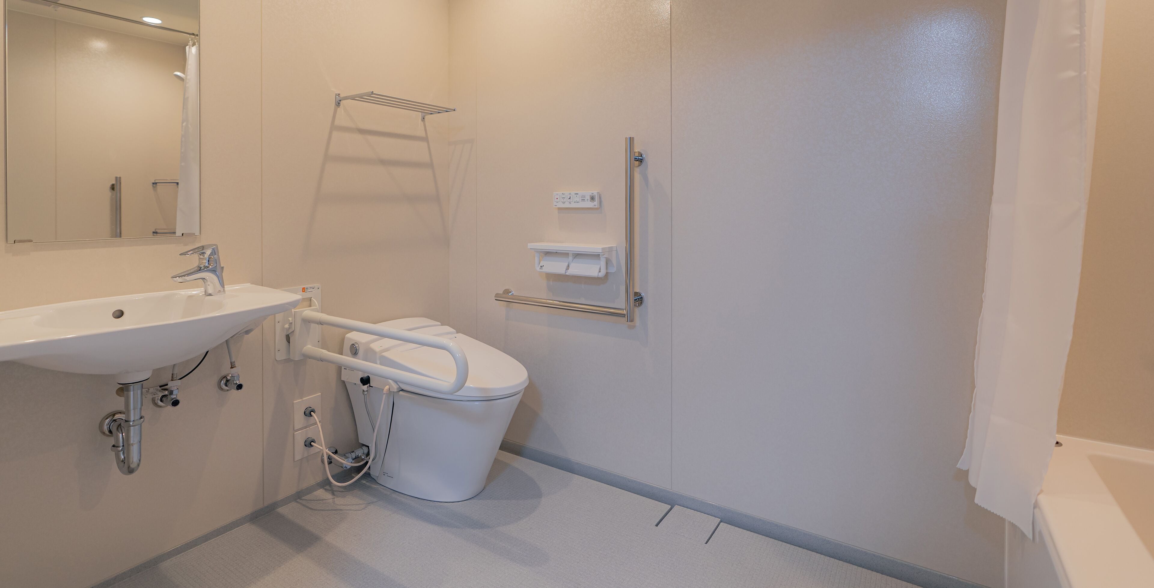 A modern bathroom with a sink, toilet, and shower.