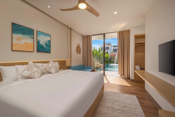 A hotel room with a large bed, a TV, a ceiling fan, and a view of a swimming pool. - Amazing Newly Built Pool Villas Danang (Da Nang)