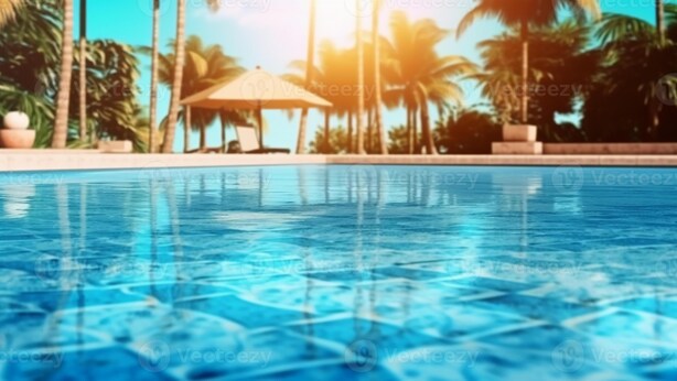 A clear view of a swimming pool with a sunlit background and palm trees. - Geoworld Apartments & Suites (Makurdi)