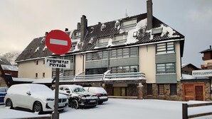 A building with a sign reading "PROPIETAT PRIVADA" and a "no entry" sign.