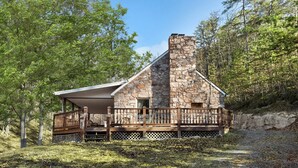 A stone cabin with a wooden deck and a covered porch. - Rustic retreat w/ kitchen & deck (Great Cacapon)