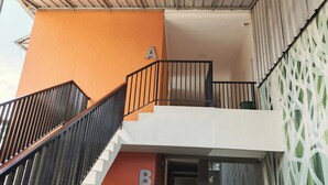 A building with a staircase leading to a balcony, marked with letters A and B. - Khanza Costel Syariah (Karangtengah)