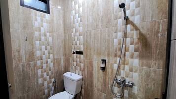 A bathroom with a toilet, a shower, and tiled walls.