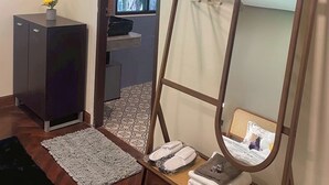 A room with a standing mirror, a small cabinet, a window, and a door leading to a bathroom. - Jaokhun Panorama Villas, Patong (Patong)