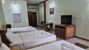 A hotel room with two beds, a desk, a television, and a small cabinet. - Tontarn Resort And Spa (Khanom)
