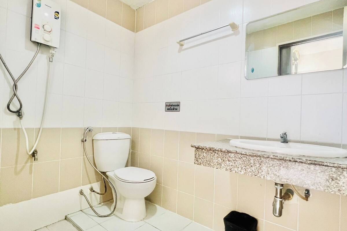 A bathroom with a toilet, sink, and shower.