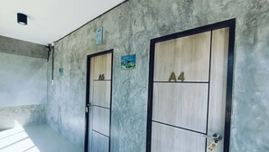 A hallway with two doors labeled A5 and A4, a light fixture on the ceiling, and a poster on the wall.