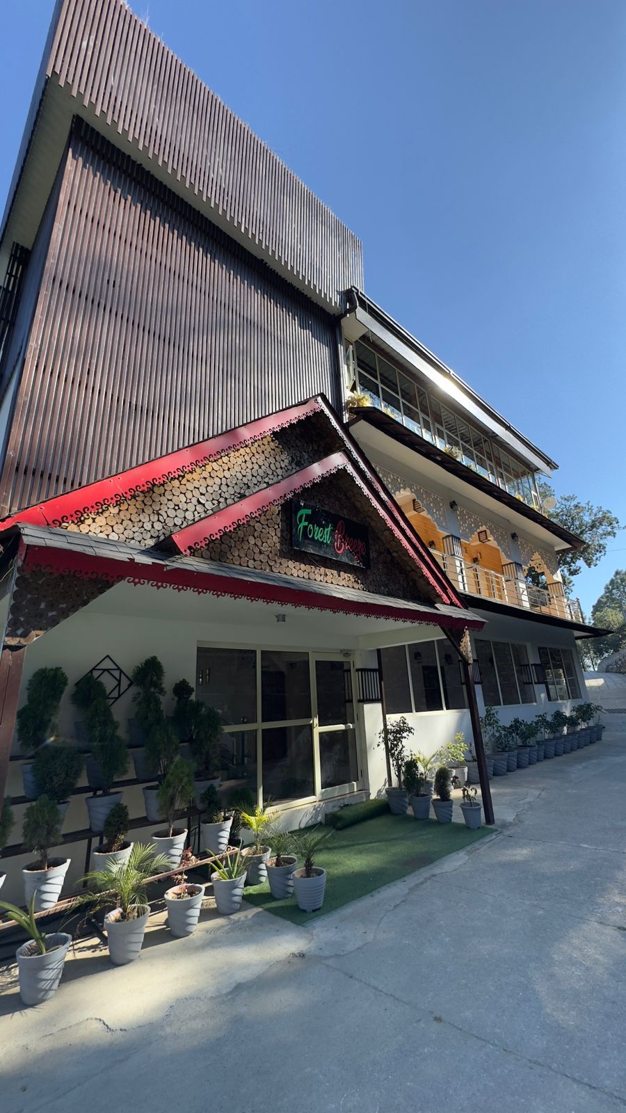 A two-story building with a sign reading "Forest Breeze."