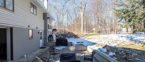 A patio with outdoor seating and a view of a snowy landscape.