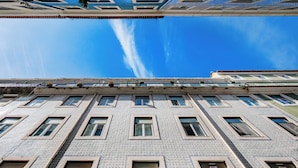 A multi-story building with a patterned facade and multiple windows.
