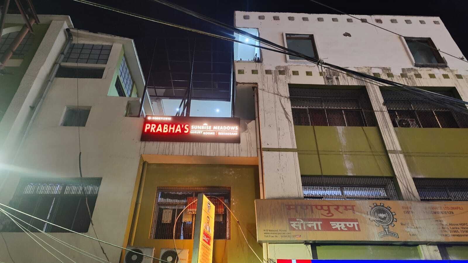 A building with a sign for 'Prabha's Sunrise Meadow' indicating a restaurant.