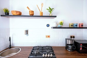 Fridge, microwave, stovetop, coffee/tea maker