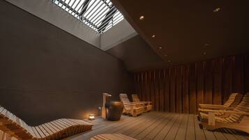 A spa area with wooden benches, a large vase, and a skylight.