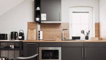 Fridge, microwave, stovetop, coffee/tea maker