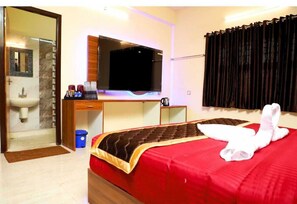 Relax in a stylish room with a large bed, desk, and flat-screen TV.