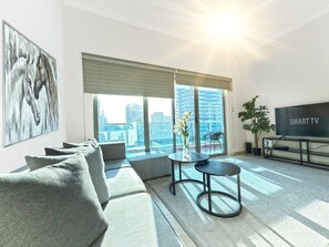 A modern living room with a sofa, a coffee table, and a TV.