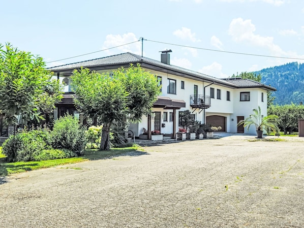 Set amidst lush greenery and mountains, this charming building offers a serene retreat.
