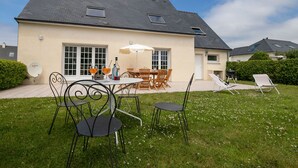 A house with a patio, outdoor furniture, and a view of neighboring houses. - Ty Stella by Interhome (Porspoder)